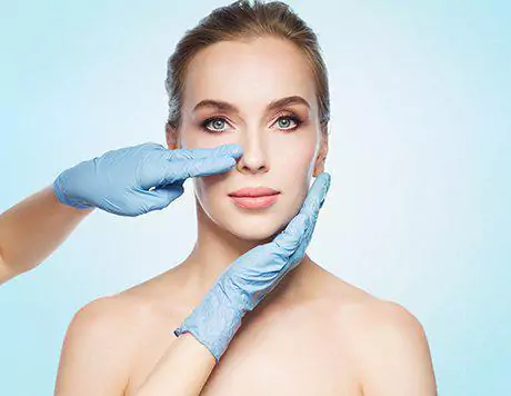 Face of a female patient who will undergo closed scarless rhinoplasty being examined by a top plastic surgeon in Beverly Hills
