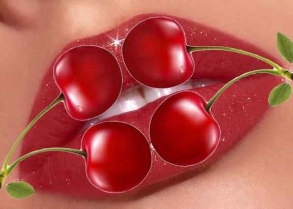 young woman's lip with two red cherries