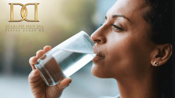 woman drinking water to stay hydrated