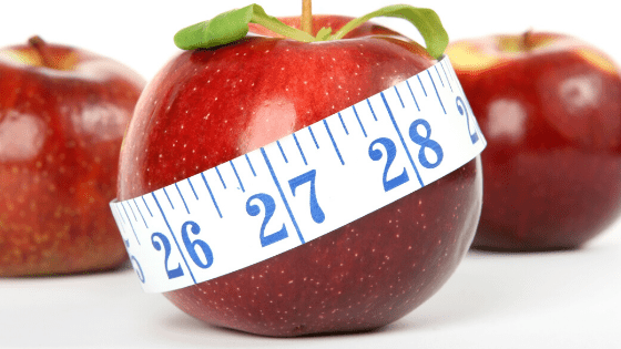apple wrapped in tape measure