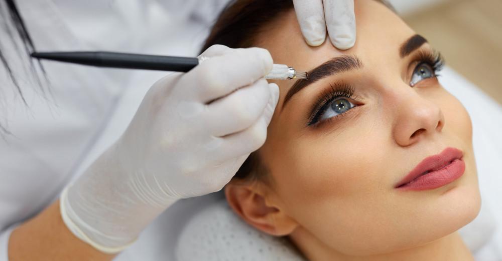 female patient undergoing a microblading on her eyebrows